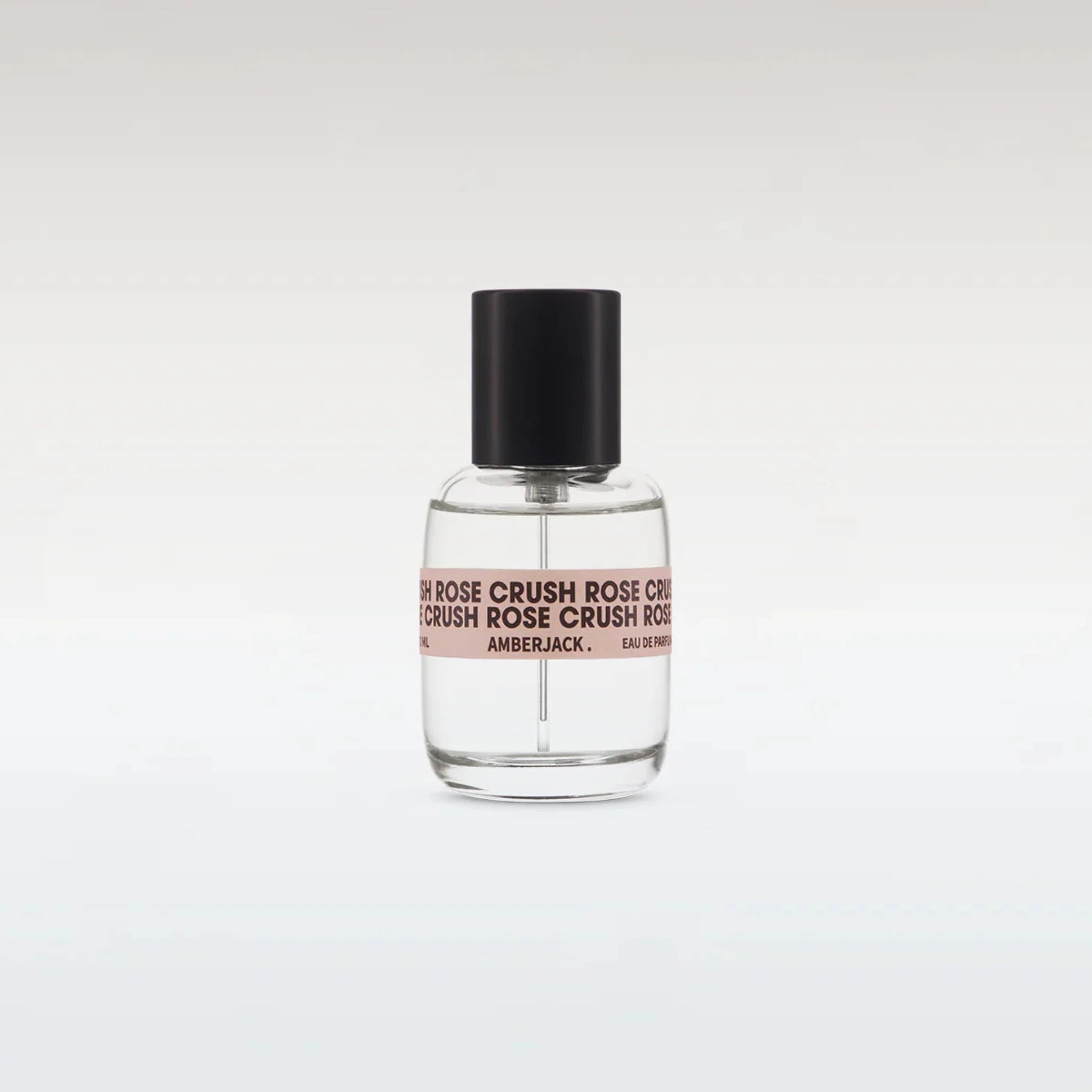 Perfume bottle with black cap and clear body on a white background
