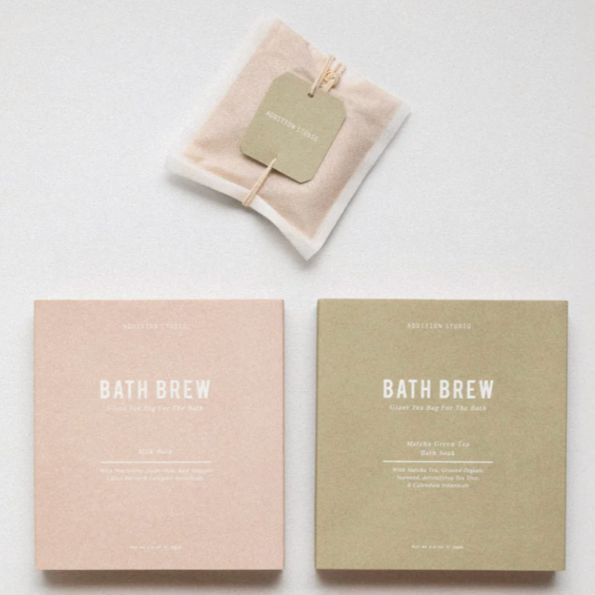 A pale pink and pale green package of bath brew blends by Addition Studio.