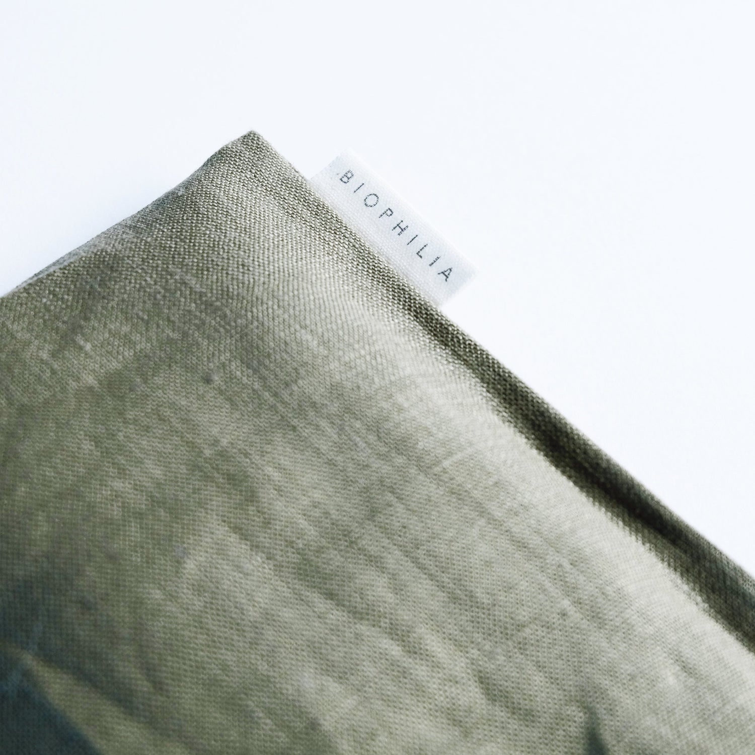 Close-up of a textured green linen eye pillow with &