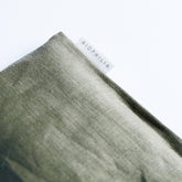 Close-up of a textured green linen eye pillow with &