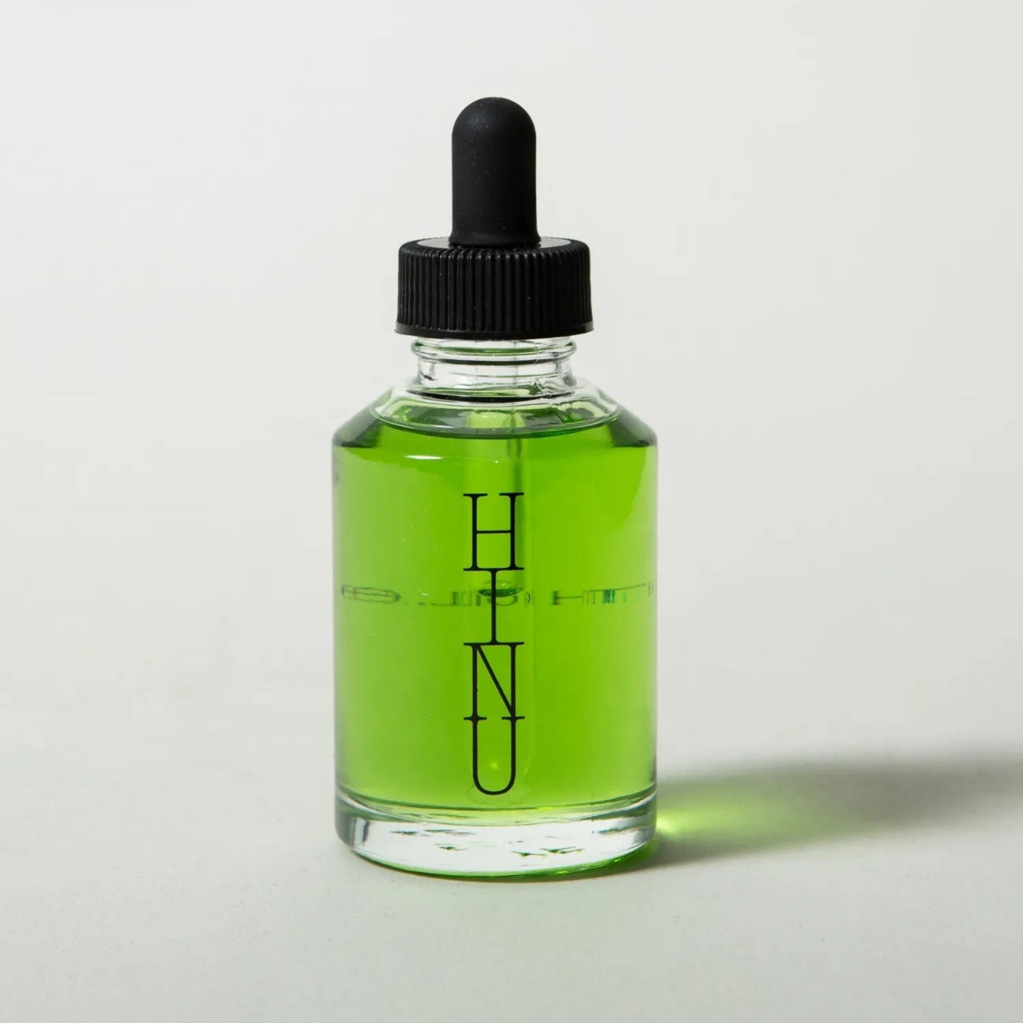 Bottle of green liquid with a dropper labeled &