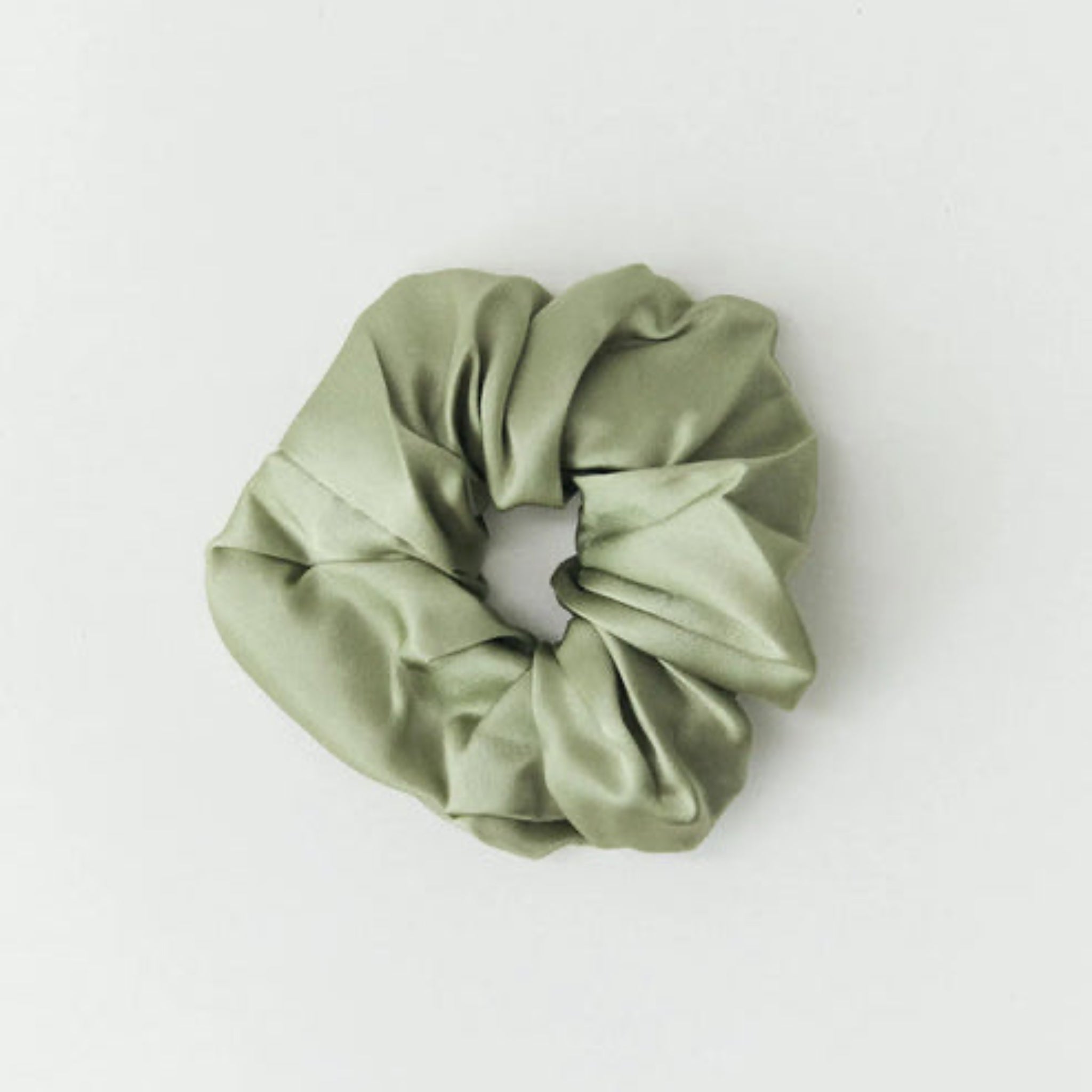 Green scrunchie on a white background