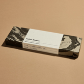 A box of Palo Santo incense on a beige surface.