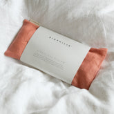 Biophilia herbal eye pillow with rose colour linen on a white fabric background