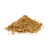 A small pile of sandalwood powder on a white surface.