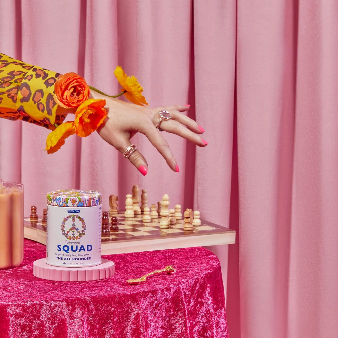 A colourful pink scene with chess and a tin of Shroom Squad by Misty Day.