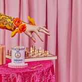 A colourful pink scene with chess and a tin of Shroom Squad by Misty Day.