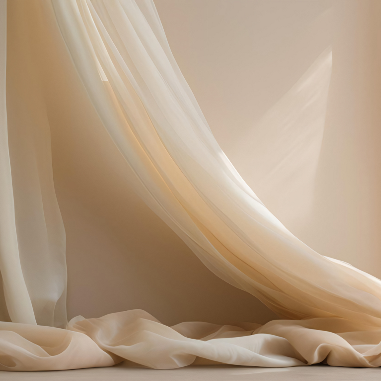 A creamy coloured silk curtain strewn across a creamy wall and over the floor in soft sunlight.
