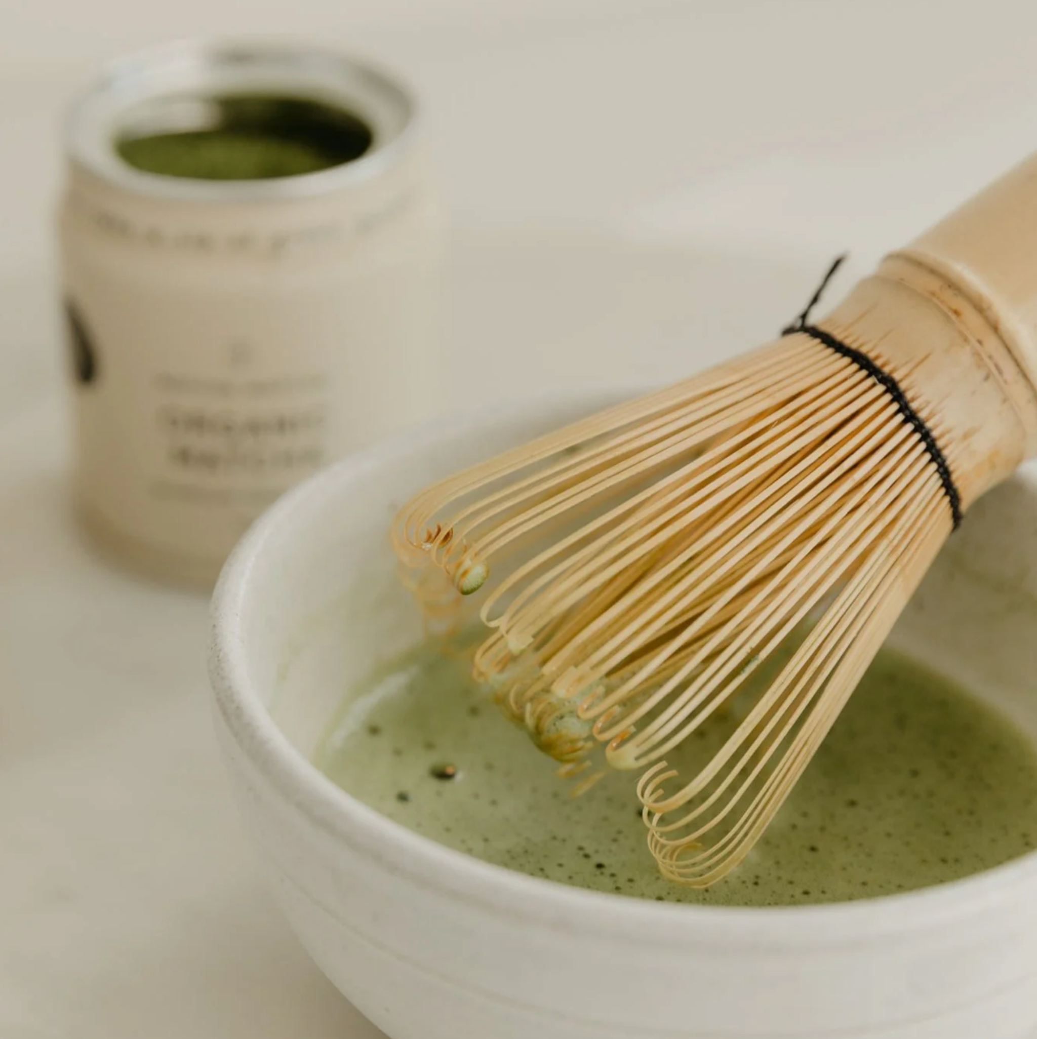 Matcha whisked in a small white ceramic bowl.