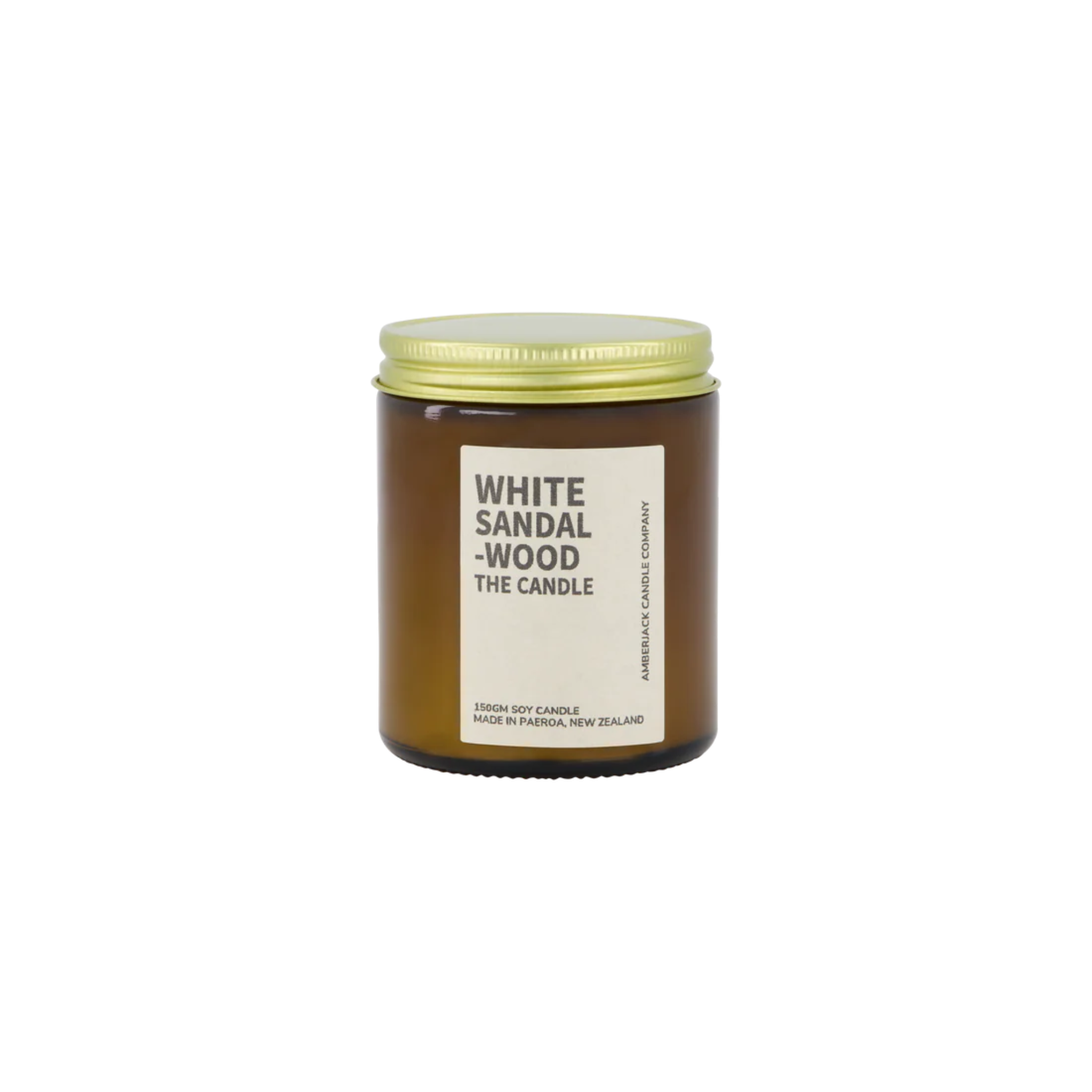 Amber glass jar with brass lid containing white sandalwood candle on white background.