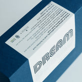 A navy blue box of the Dream Tea blend.