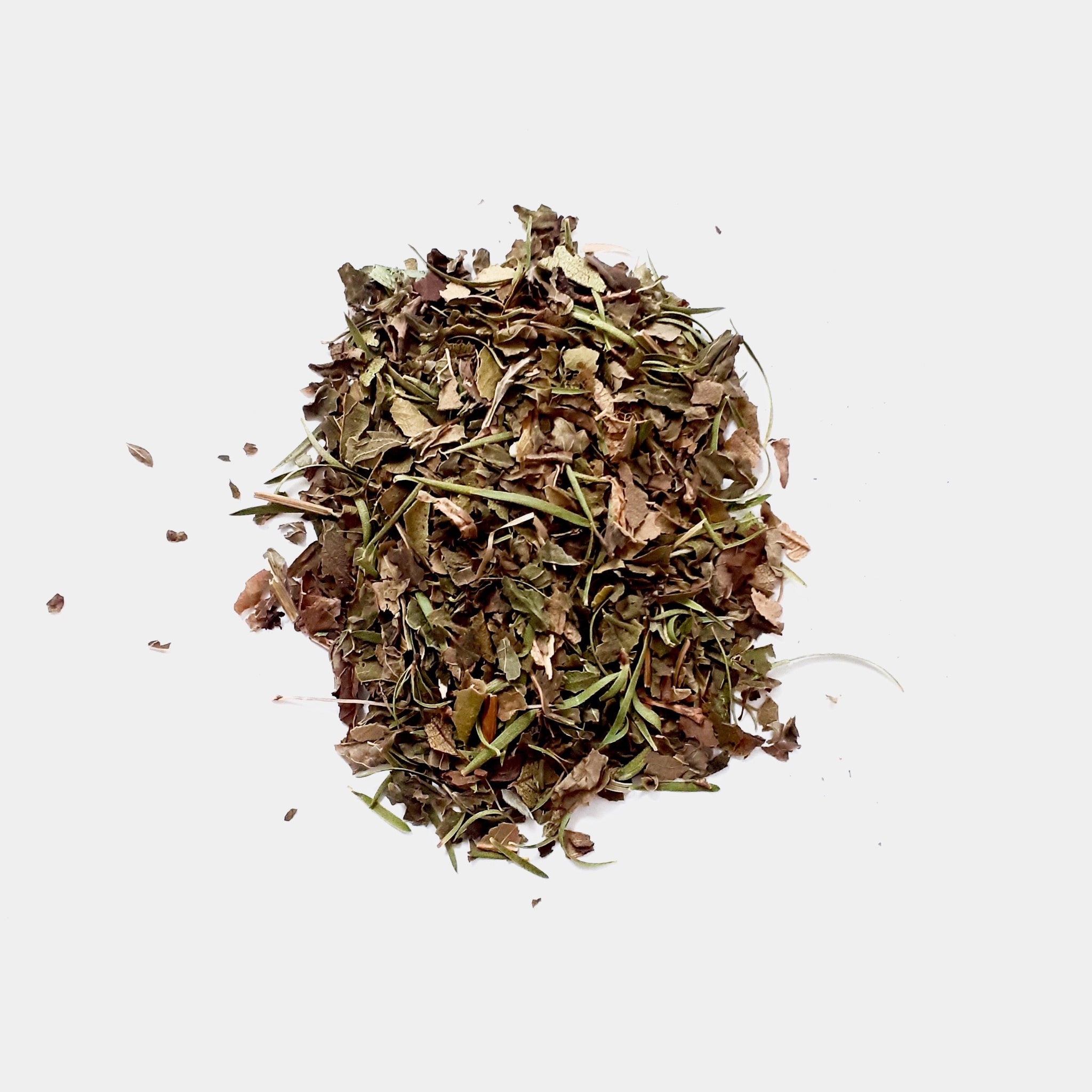 A small bunch of the Rest and Digest herbal tea blend on a white surface.