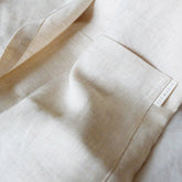 Close-up of a beige fabric with a brand label on a light background