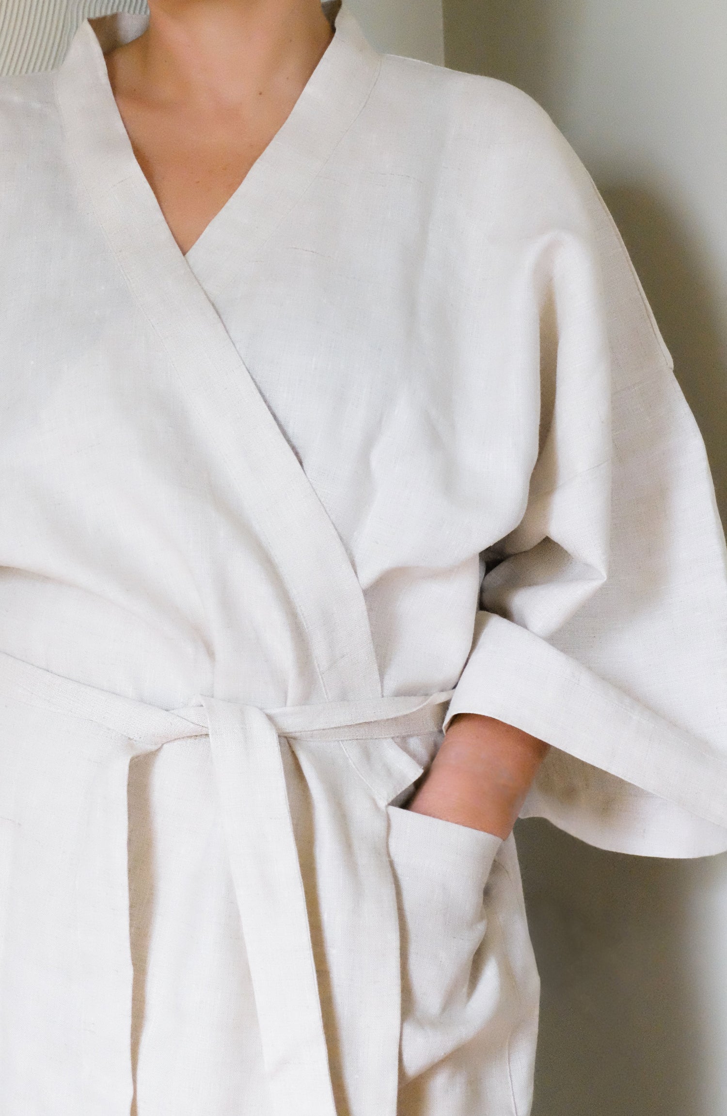 White robe worn by a person against a neutral background