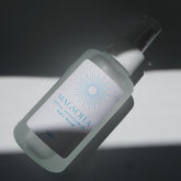 MAGSOLEA magnesium oil for kids bottle with label on a dark background