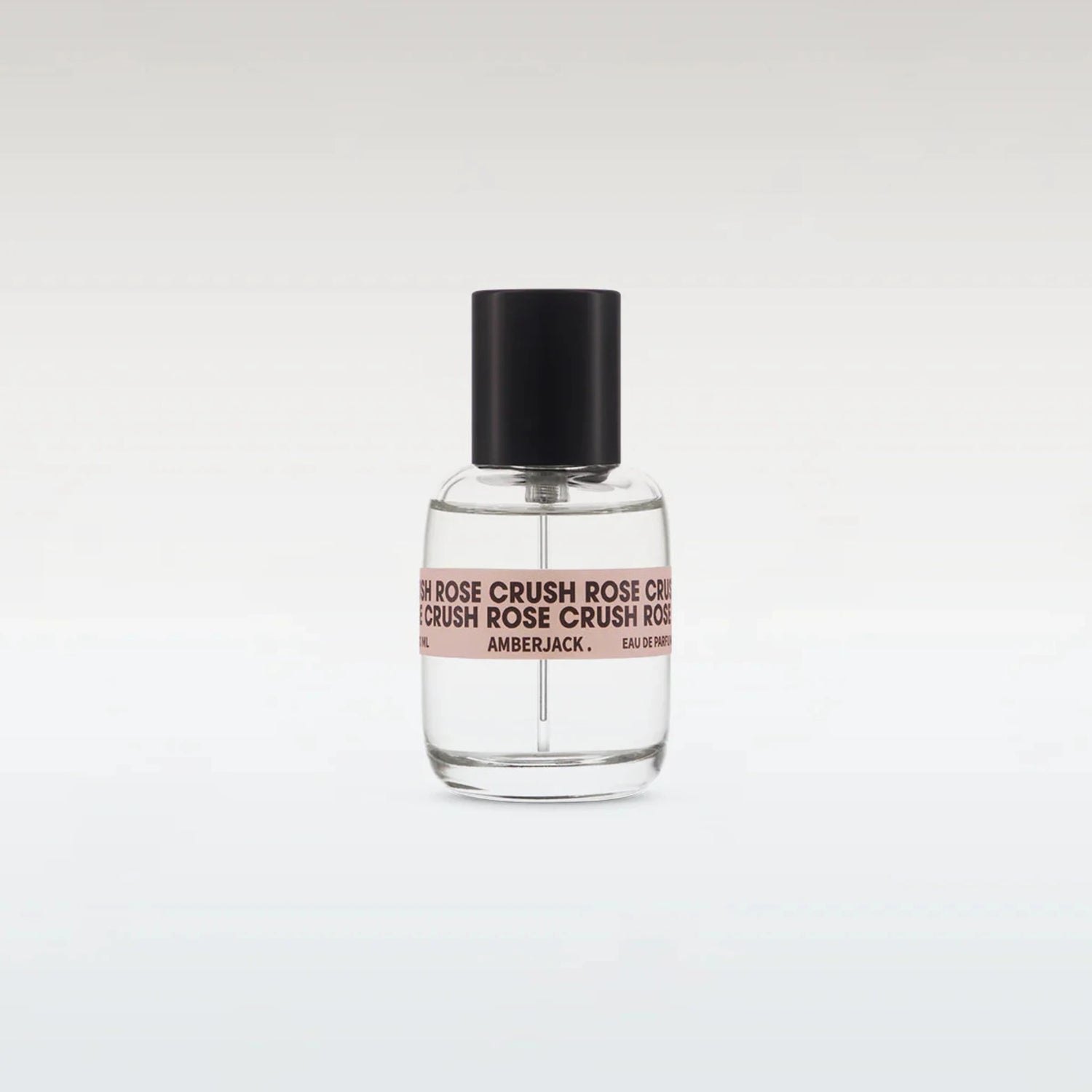 Perfume bottle with black cap and clear body on a white background