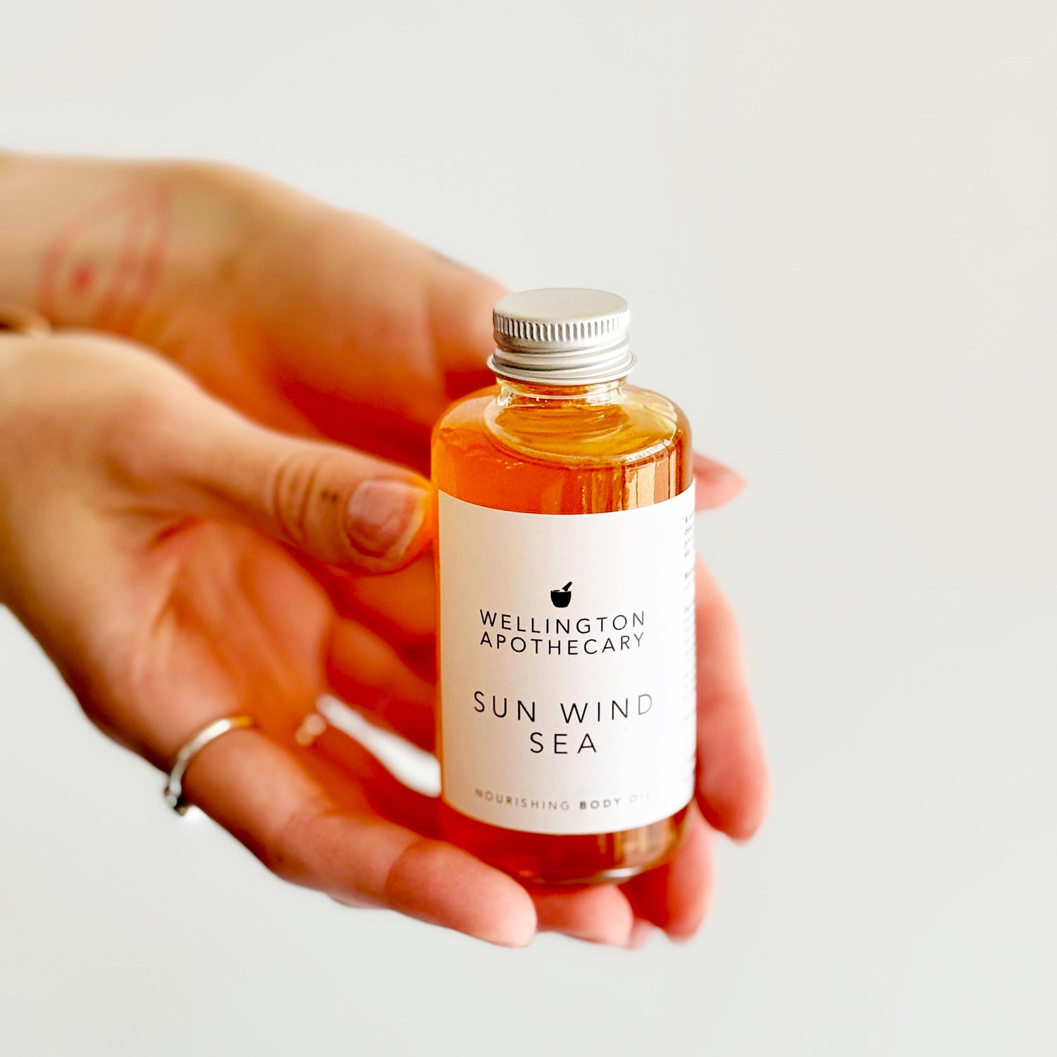 Hand holding a bottle of &