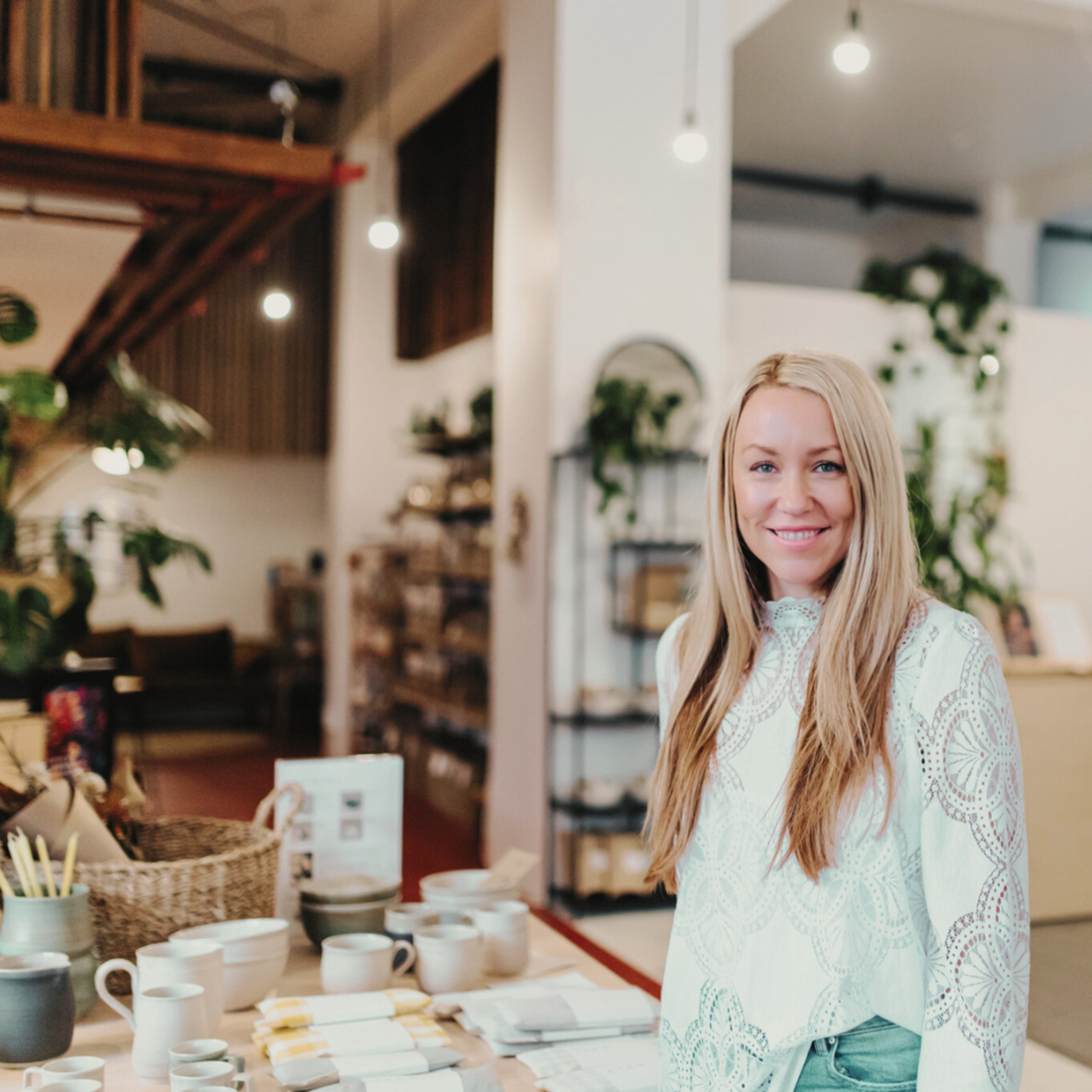 Woman standing in a store with various items on display