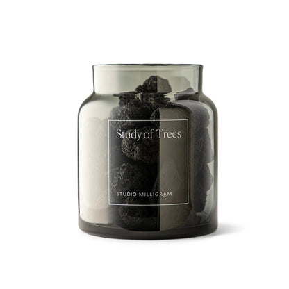 Clear glass jar with black volcanic rocks  and &