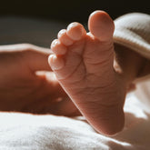 Close up of the sole of a babies foot in soft sunlight. 