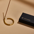 A circle shaped brass incense holder by Subtle Bodies. 