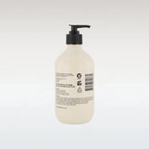 Beige bottle with black pump on a white background