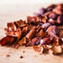 Cacao husks strewn on a wooden bench. 