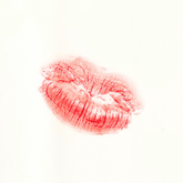 Pouted lip stain on tissue with Carmín lip tint. 