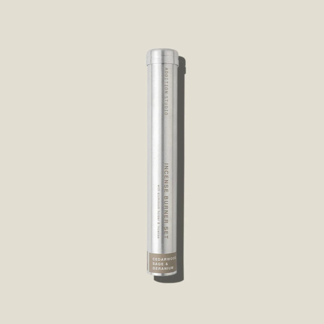 An aluminium tube containing cedarwood, sage and geranium incense sticks and holder. 