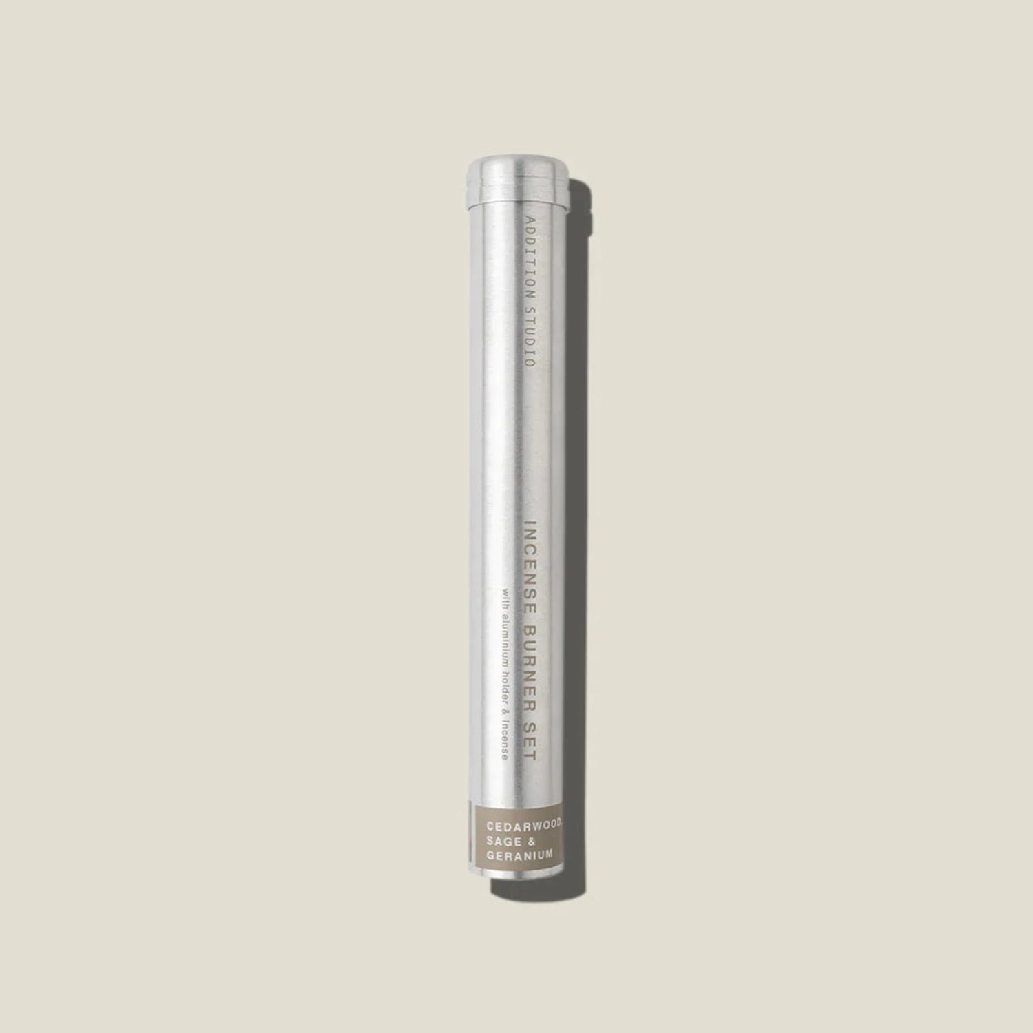 An aluminium tube containing cedarwood, sage and geranium incense sticks and holder. 