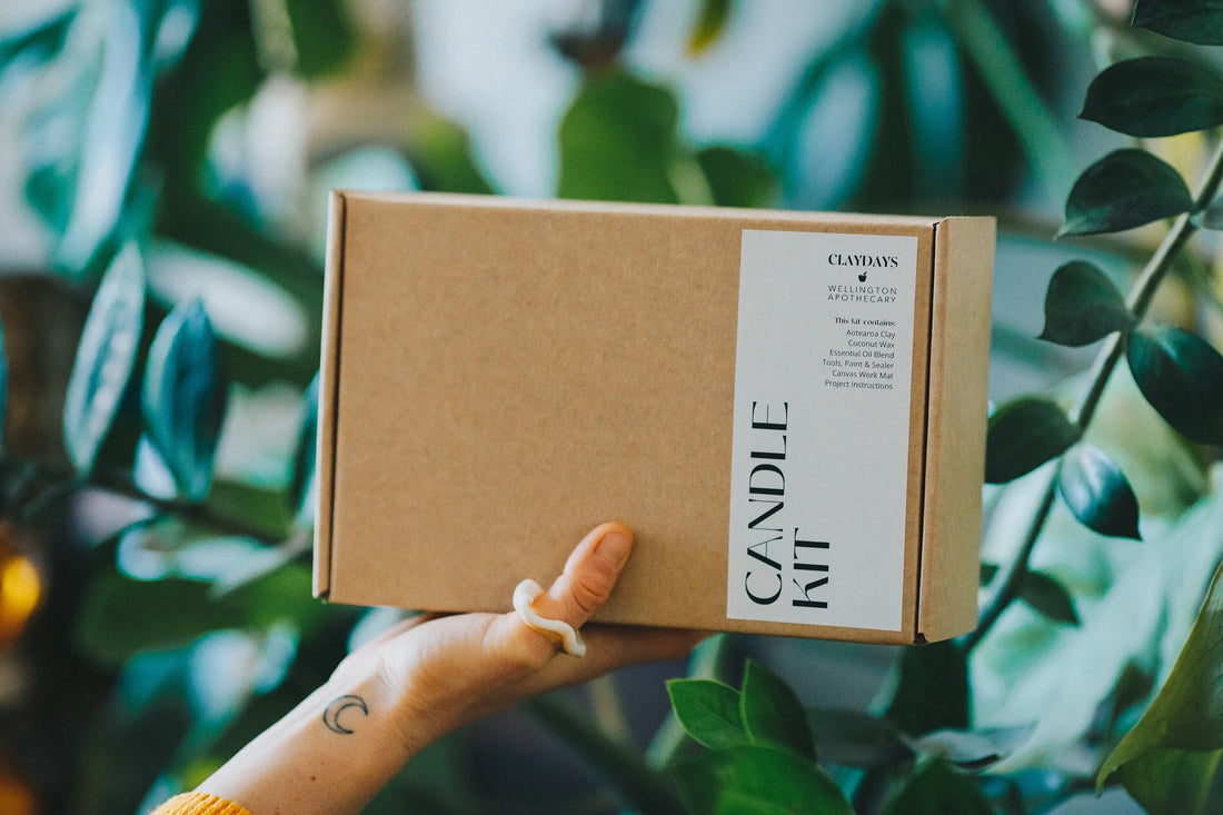 Hand holding a cardboard box labeled &