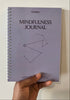 Hand holding a mindfulness journal titled &