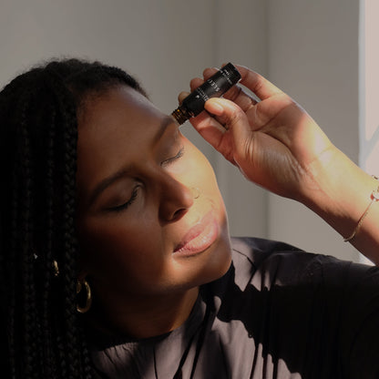 Person applying a roll on sleep blend to their temples
