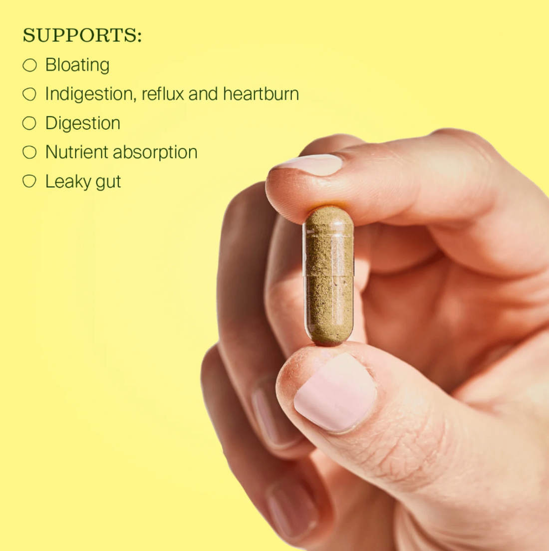 Hand holding a supplement pill