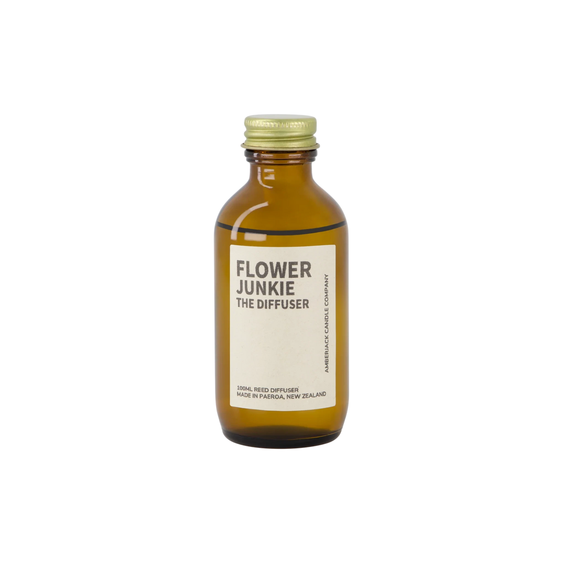 An amber bottle of Flower Junkie scent as a reed diffuser. 