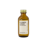 An amber bottle of Flower Junkie scent as a reed diffuser. 