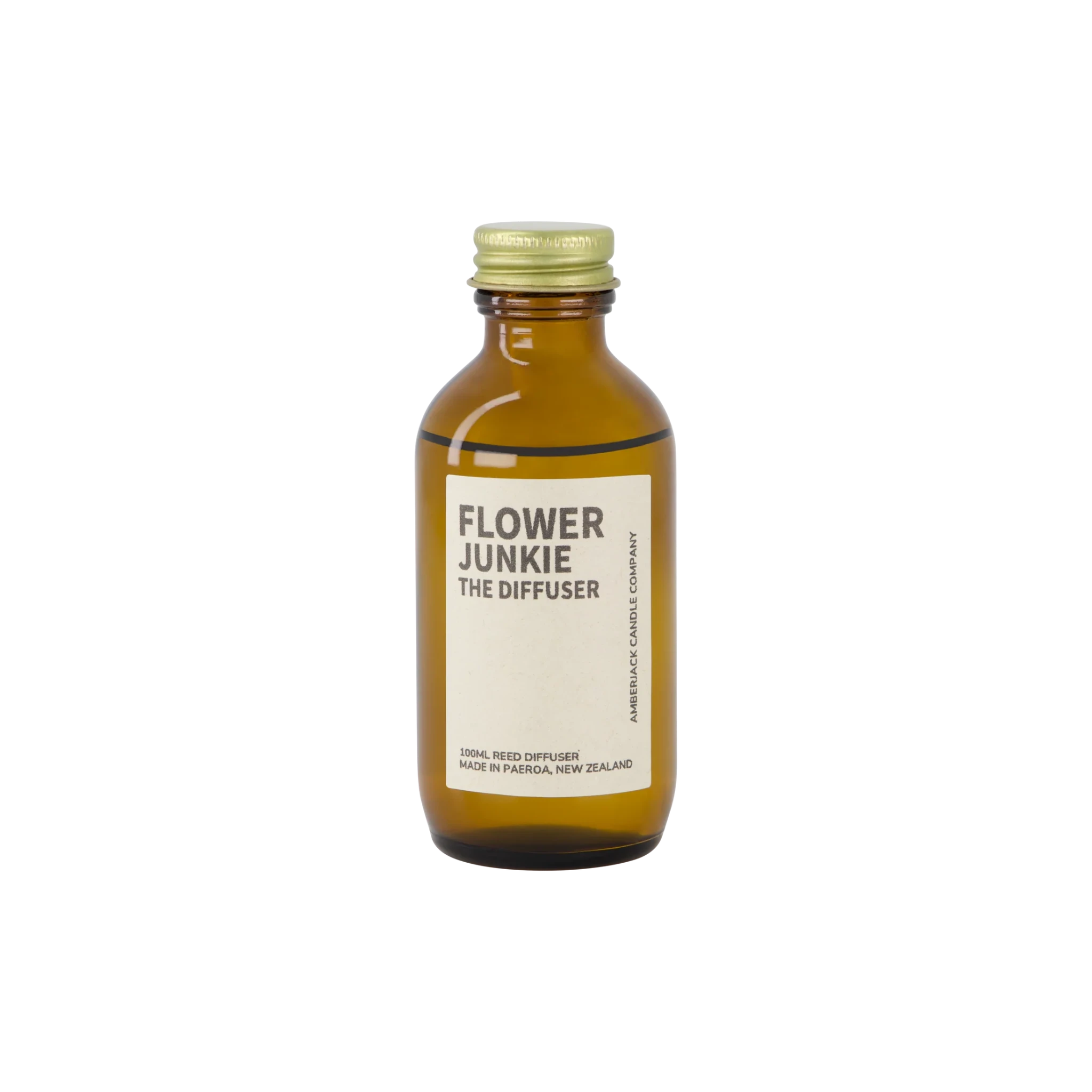 An amber bottle of Flower Junkie scent as a reed diffuser. 