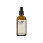 An amber glass bottle of Flower Junkie room spray by Amberjack. 