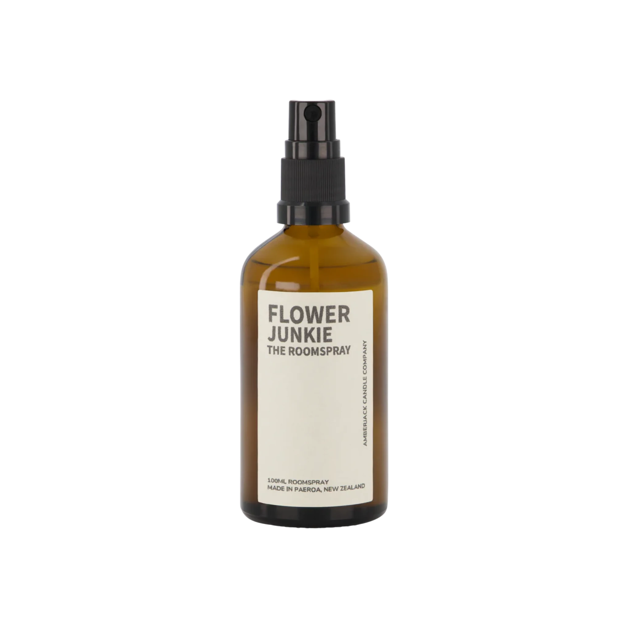 An amber glass bottle of Flower Junkie room spray by Amberjack. 
