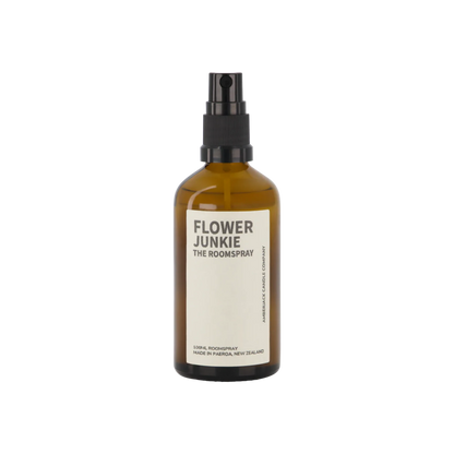 An amber glass bottle of Flower Junkie room spray by Amberjack. 