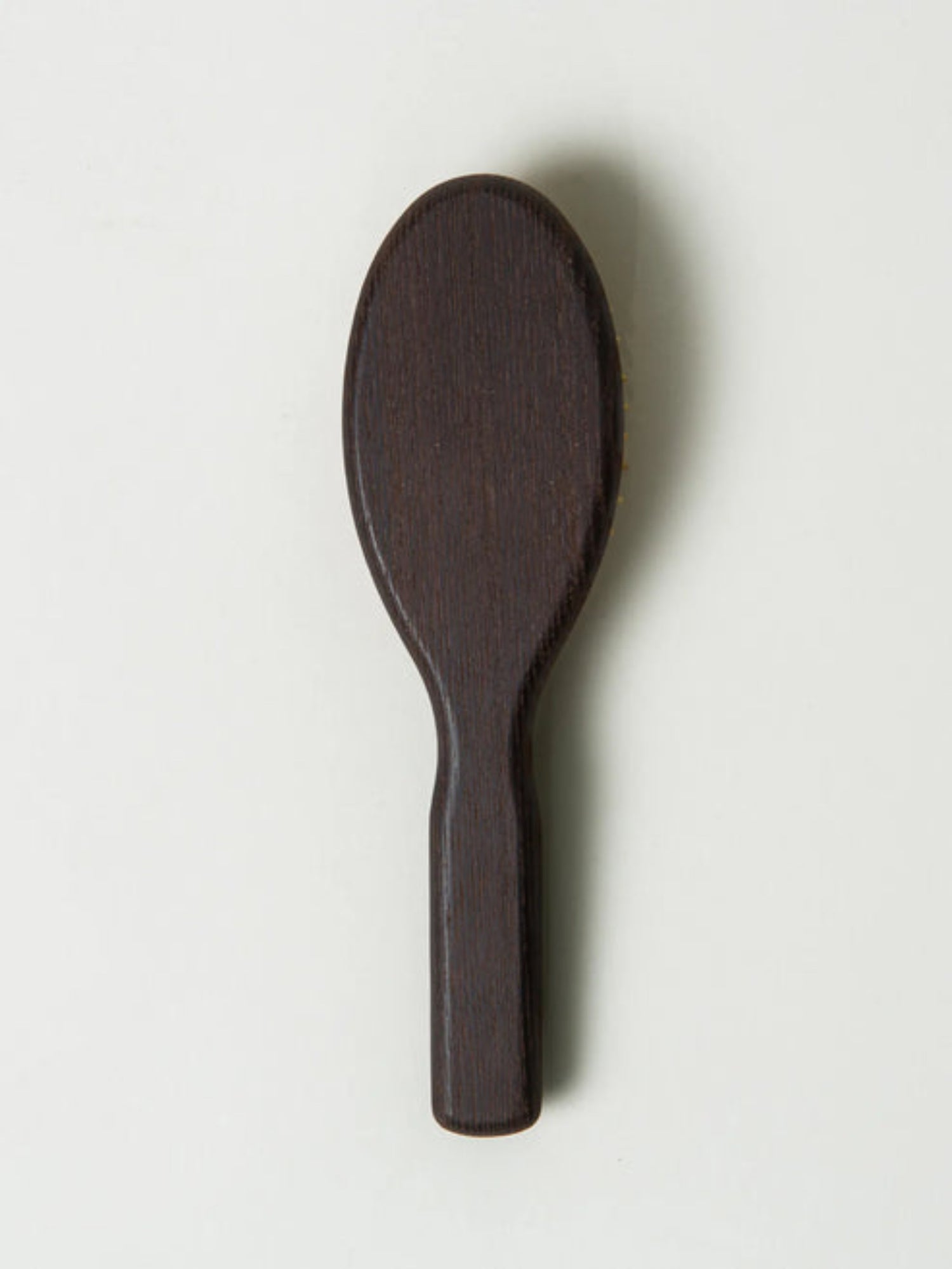 Dark wooden spoon on a light gray background
