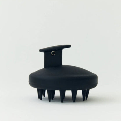 Black scalp massager on a white background
