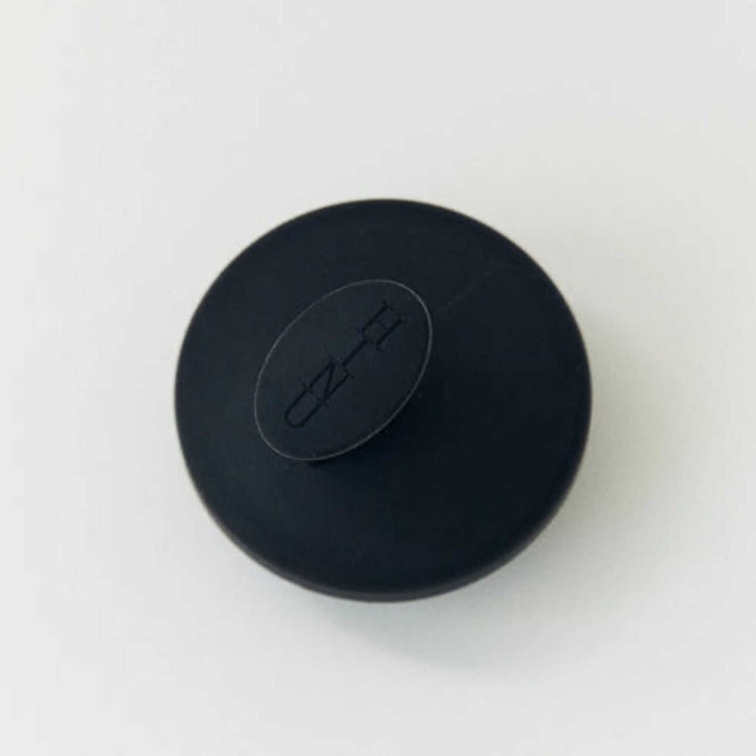 Black scalp massager on a white background