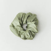 Green scrunchie on a white background