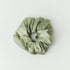 Green scrunchie on a white background