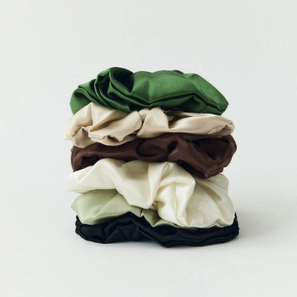 Stack of colorful scrunchies on a white background