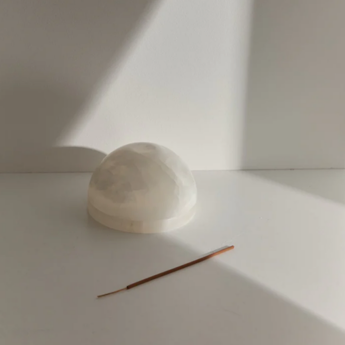 A white stone dome incense holder.