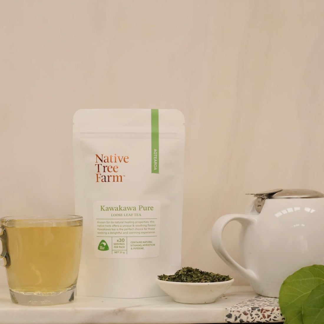 Dried Kawakawa leaves in a small bowl and infused in a white teapot. 