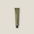 Green lip balm tube on a beige background