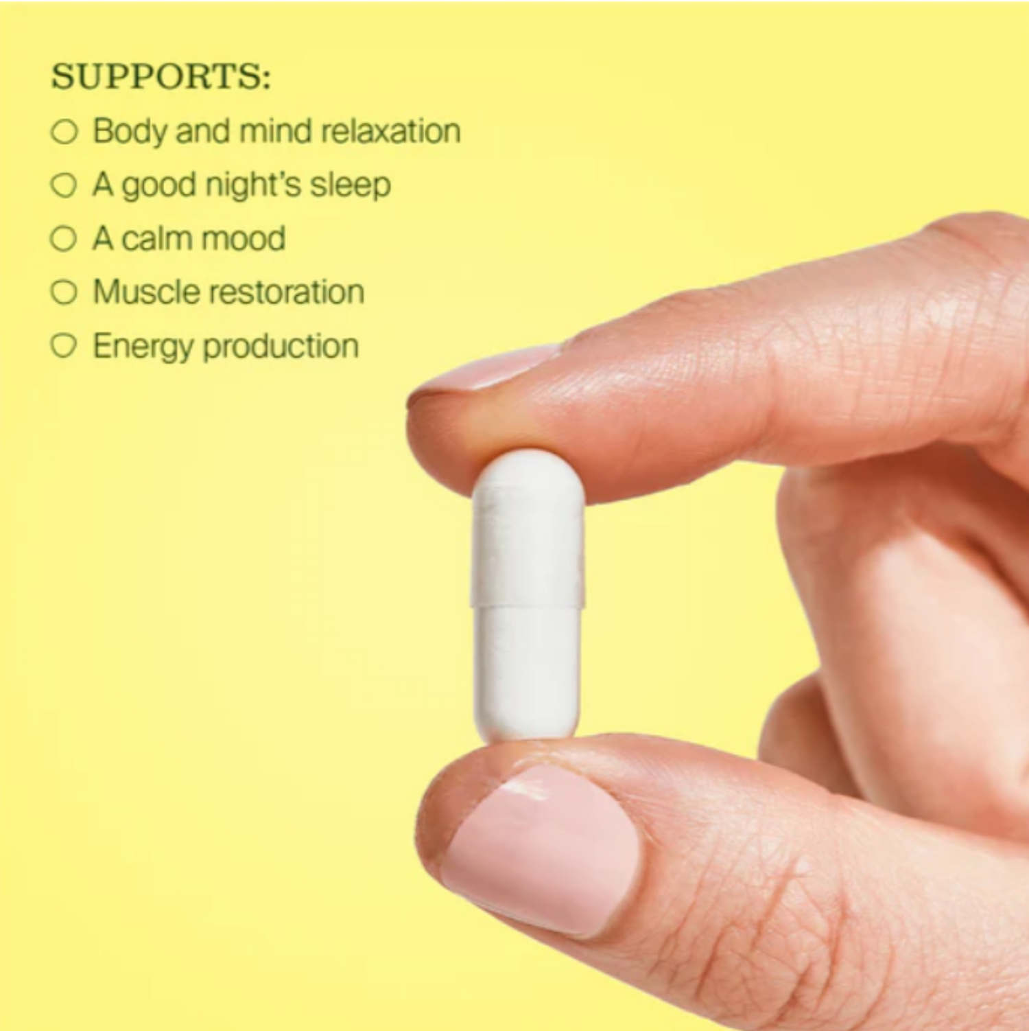 Hand holding a white capsule with text on a yellow background